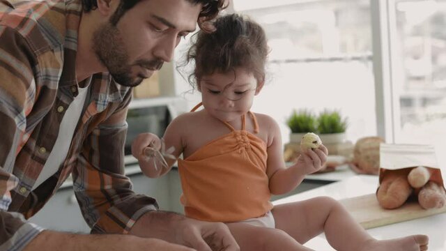 young hispanic father with his little daughter makes cookies at home. 