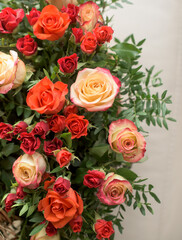 Bouquet of red, orange, yellow roses- a composition of multi-colored roses. Background for a postcard.