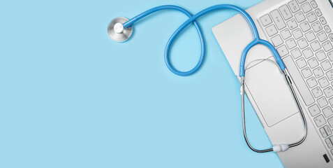 Online doctor consultation, Virtual hospital and online therapy. Doctor online. Stethoscope Laptop Computer on blue background. copy space. top view