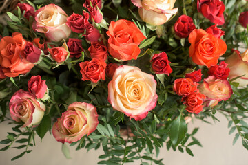Bouquet of red, orange, yellow roses- a composition of multi-colored roses. Background for a postcard.