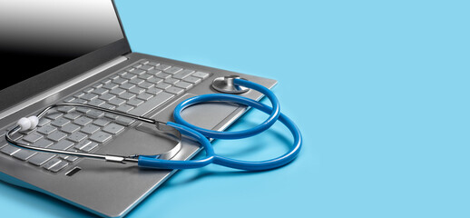 Laptop With Medical Diagnostic Software And Stethoscope. Stethoscope And Laptop isolated on blue background. Telehealth concept. Online doctor consultation, copy space. banner
