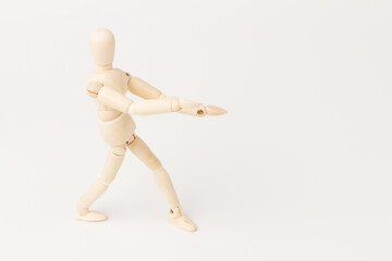 A wooden mannequin isolated against a white background