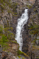 Towering waterfall falling from the rock, Finnmark, northern Norway.