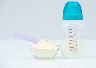 Powdered Milk, Baby Formula with spoon infant formula in bowl and bottle for feeding baby