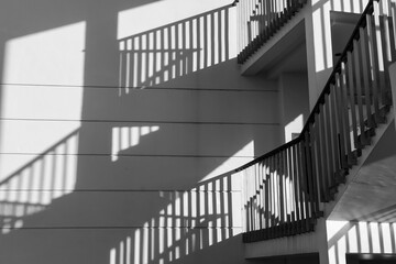 Architectural shadows by building stair hitting light