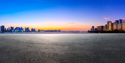 Race track road and Hangzhou skyline with buildings at sunrise.
