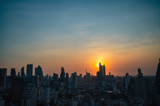 Bangkok Cityscape view with beautiful Sunset and silhouette of the building.Bangkok is the capital and most populous city of Thailand. © Sumeth