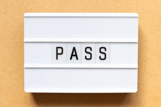 Lightbox with word pass on wood background