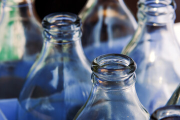 Close-up view of glass bottles stacked in crates.