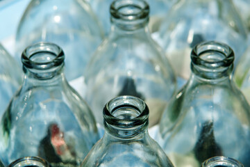 Close-up view of glass bottles stacked in crates.