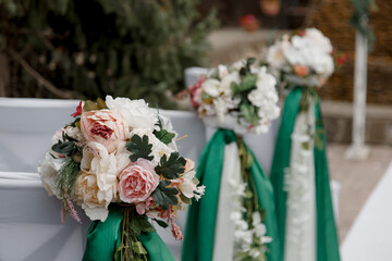 chairs decorated with flowers and ribbons