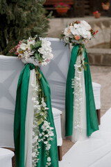 chairs decorated with flowers and ribbons