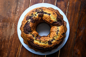Homemade chocolat-orange cake on a dark wood background.