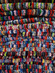 Colorful towels arranged in a layer for background.