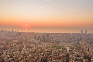 Fototapeta na wymiar Aerial drone shot of rising sun over Barcelona city beach
