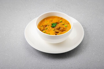 creamy peas and mushroom curry in a white bowl
