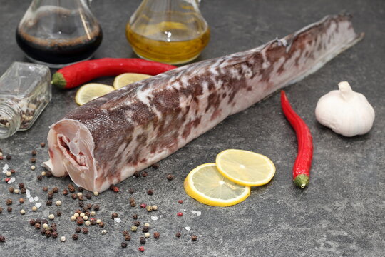 fresh fish with spices oil and pepper on the table
