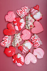 Closeup of variation of different cookies for valentine's day. Heart, love and kiss cookie on pink background. Present gift or background for Valentine or Mother's day. Lovely sweet gift or postcard
