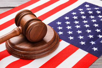 Close-up wooden judge hammer on the usa flag. Judge gavel on the american flag.