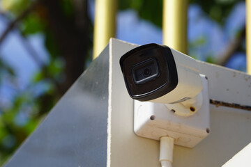 Dirty CCTV cameras are installed on the eaves for detecting property theft. CCTV security camera outdoors.