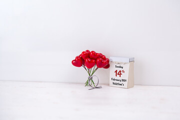 Bouquet of red hearts with a paper block