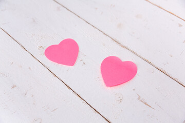 Pink hearts post-its on wooden background