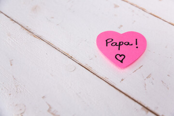 Pink heart with papa text on wooden background