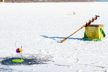 fishing rod for winter fishing on snow-covered ice surface.