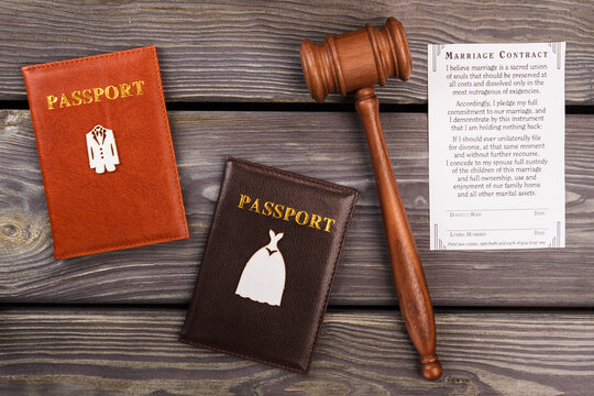 Marriace contract flat lay. Top view married couple passports with gavel.