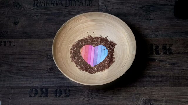 Valentine's Day heart made of sprinkled linseed in a tricky animation