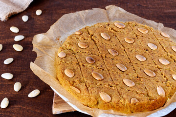 Round cake with almonds, fenugreek seeds and semolina. Sweet traditional helbeh dessert.