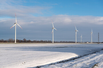 Wind farm for electric power production. Winter landscape in northern Poland. Europe
