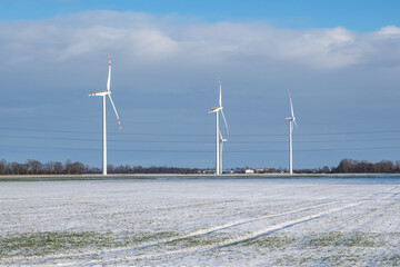 Wind farm for electric power production. Winter landscape in northern Poland. Europe