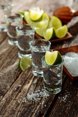 Tequila with salt and lime slices.