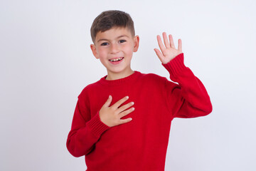 I swear, promise you not regret. Portrait of sincere Little cute boy kid wearing red knitted...