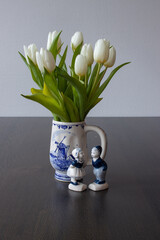 White dutch tulip on a table and Delft blue decor