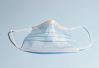 Medical mask on a blue background. Health. Pandemic covid 19.