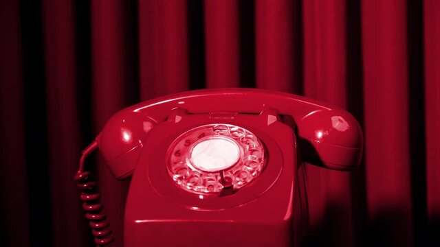 A classic rotary telephone spinning and changing colour