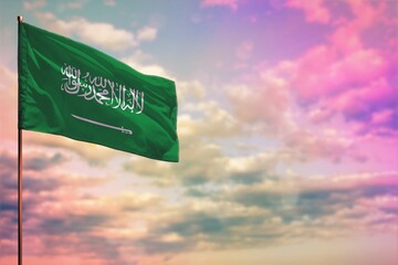 Fluttering Saudi Arabia flag mockup with the space for your content on colorful cloudy sky background.