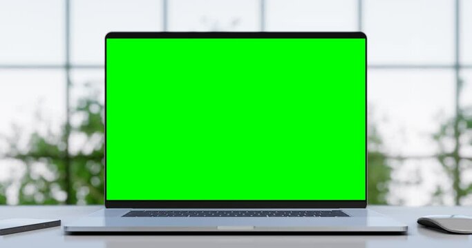 Laptop with blank green screen in office interior. Smooth camera movement with bokeh background. Home interior or office, 4k 60fps UHD