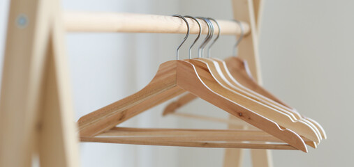 empty clothes hangers hanging on a clothes rack in the bedroom. copy spase