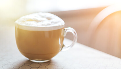 Large cup of coffee with foam on the table. Energy drink on light background