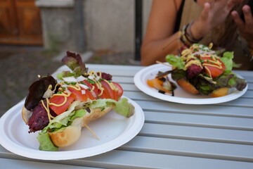 a delicious hotdog with salad, tomato and mayonese