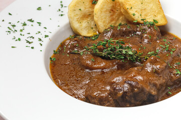 Homemade stew of osso buco meat with aromatic herb sauce