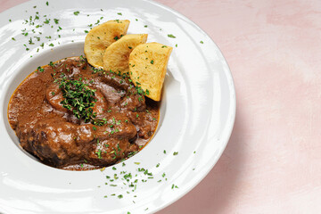 Homemade stew of osso buco meat with aromatic herb sauce