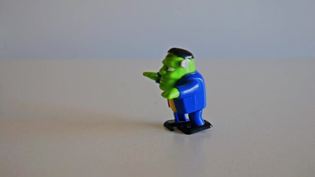 Funny Frankenstein wind-up plastic toy walks rigth to left. Full HD 1080p. Still frame.
