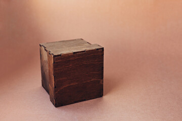 Wooden gift box on color background.