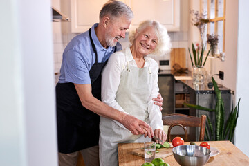 Fototapeta na wymiar mature couple cooking together, friendly married couple enjoy spending time in the kitchen at weekends