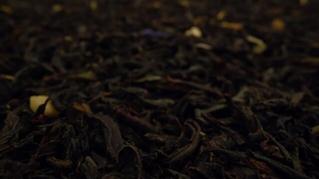 extremely close-up dried black tea leaves background. Dolly Shot