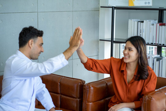 Medical doctor Psychologist in healing session with young Asian woman depressed mental sickness patient in the clinical office